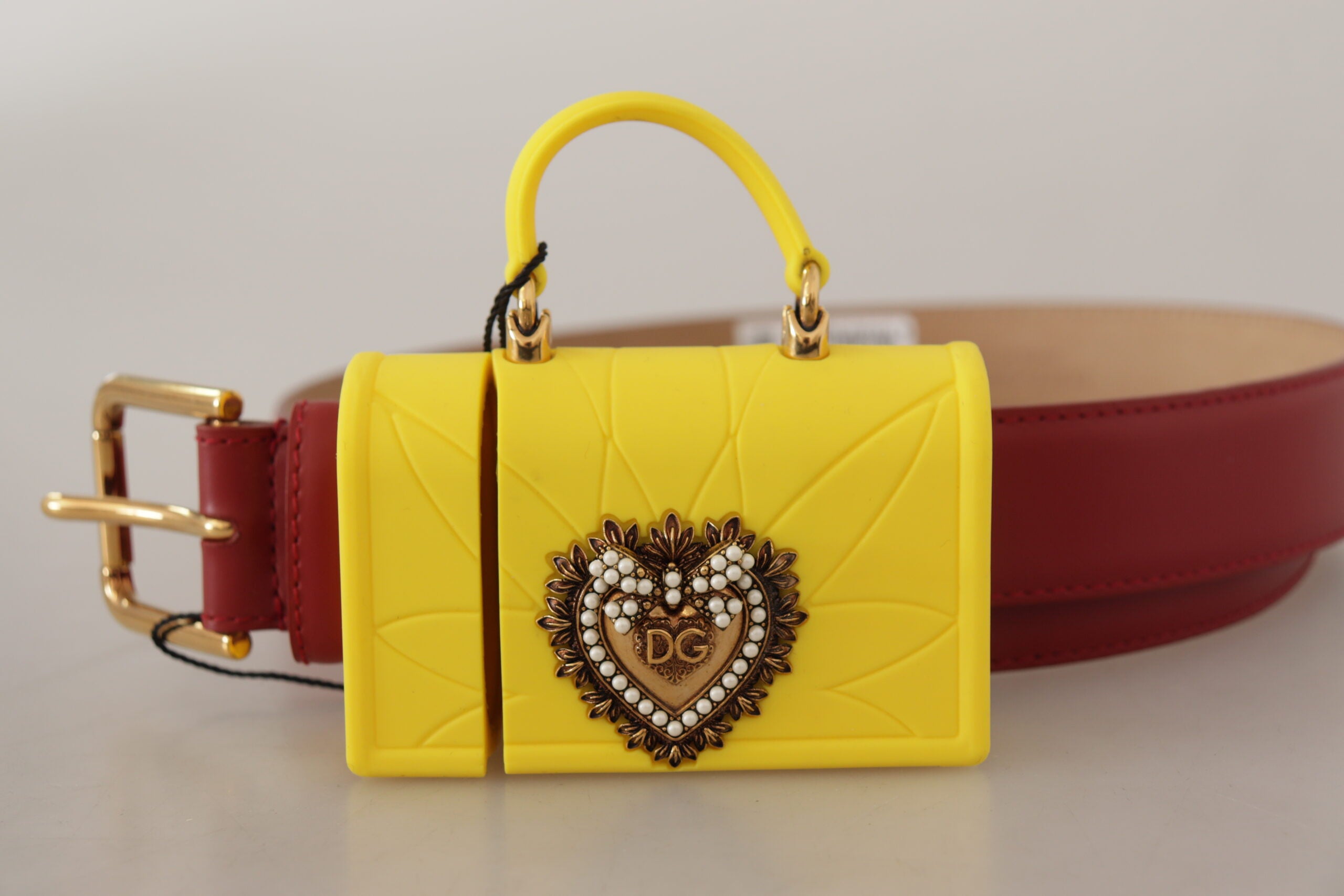 Red leather heart-shaped belt with a yellow DEVOTION buckle by Dolce & Gabbana, featuring a stylish and bold design.