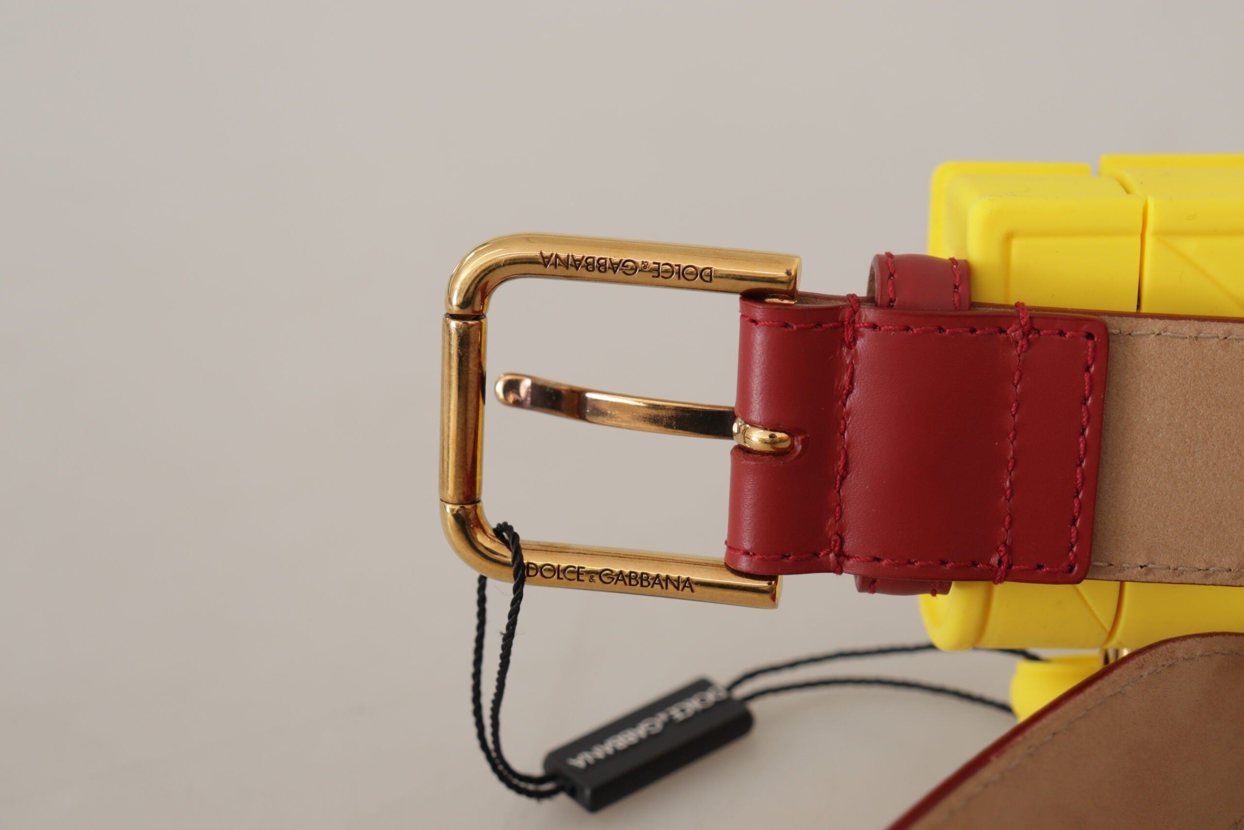 Red leather heart-shaped Dolce & Gabbana DEVOTION belt with yellow buckle and gold accents, featuring a stylish heart motif.