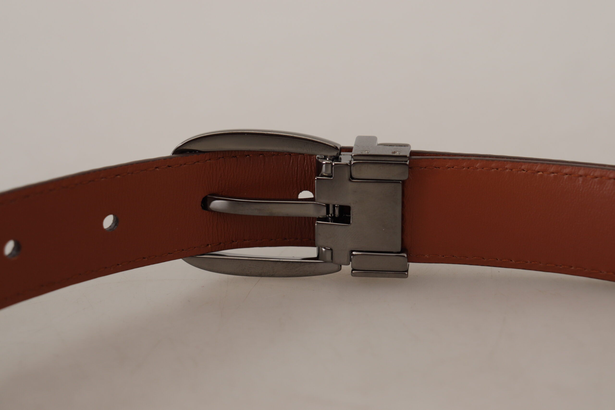 Brown leather belt with leopard embossing and a buckle, by Dolce & Gabbana, showing detailed animal print and craftsmanship.