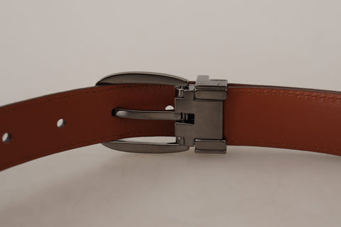 Brown leather belt with leopard embossing and a buckle, by Dolce & Gabbana, showing detailed animal print and craftsmanship.