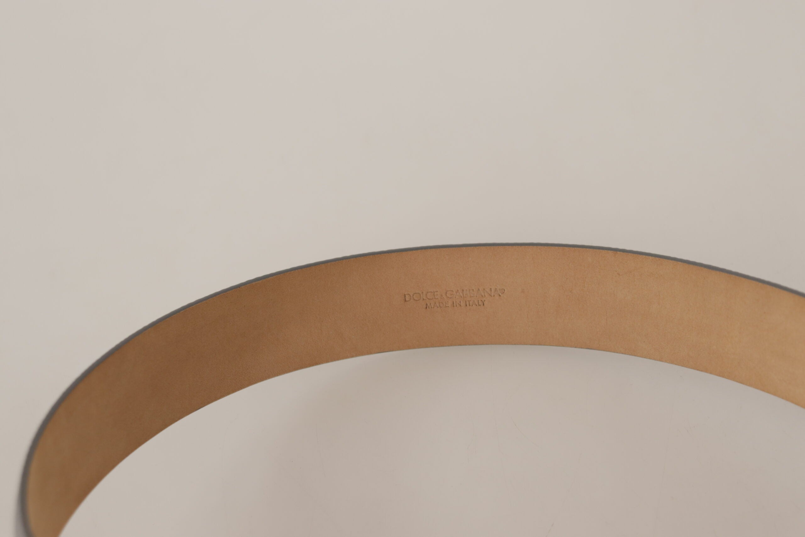 Metallic silver leather waist belt with metal buckle by Dolce & Gabbana, featuring a sleek and shiny finish.