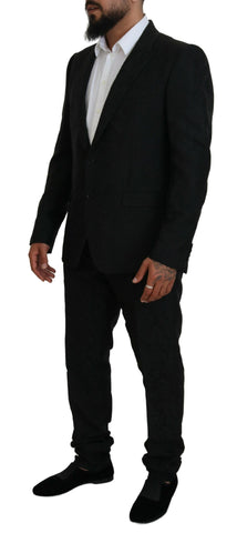 Black Dolce & Gabbana single-breasted 2-piece Martini suit, featuring tailored fit and classic lapel, displayed on a mannequin.