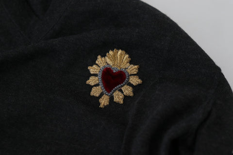 Gray cashmere V-neck sweater with gold heart detail by Dolce & Gabbana, showing the soft texture and stylish design.
