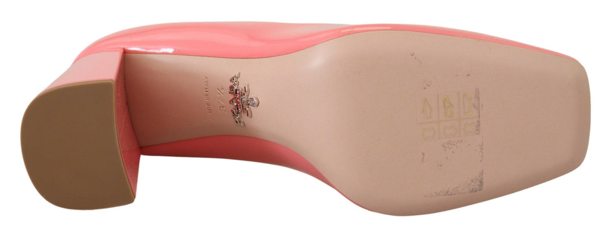 Pink patent leather Prada block heels pumps with a classic design, featuring a rounded toe and sturdy heel.