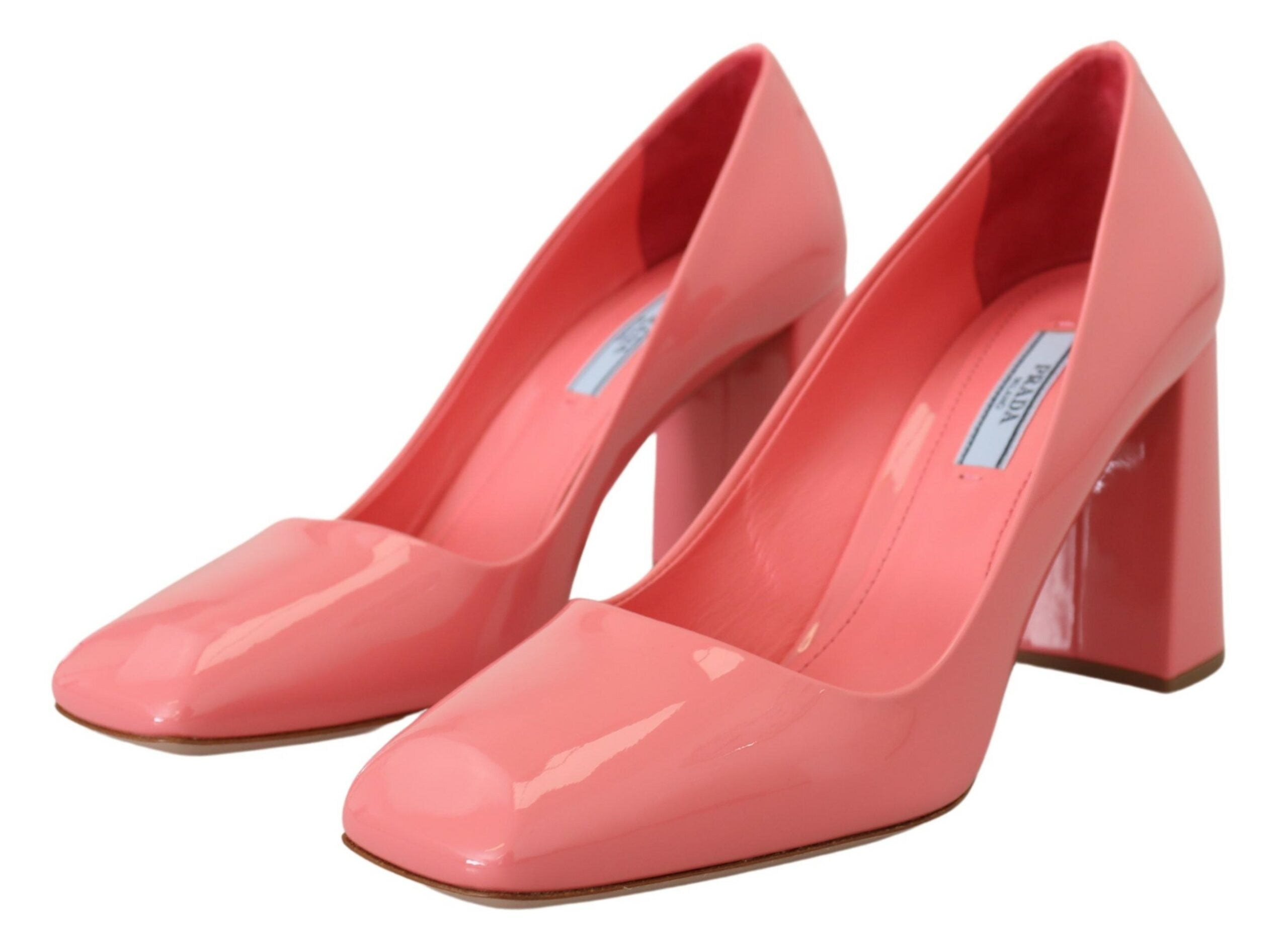 Pink patent leather Prada block heel pumps with a classic design and rounded toe, showcasing elegant footwear style.