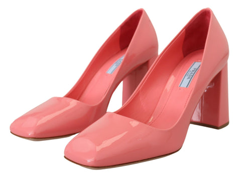 Pink patent leather Prada block heel pumps with a classic design and rounded toe, showcasing elegant footwear style.