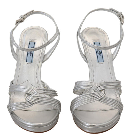 Silver leather Prada ankle strap stiletto sandals with heel and open toe, stylish footwear for women.
