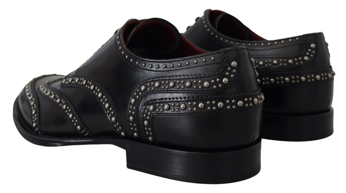 Black leather Derby dress shoes with studded accents by Dolce & Gabbana, featuring a polished finish and classic lace-up design.