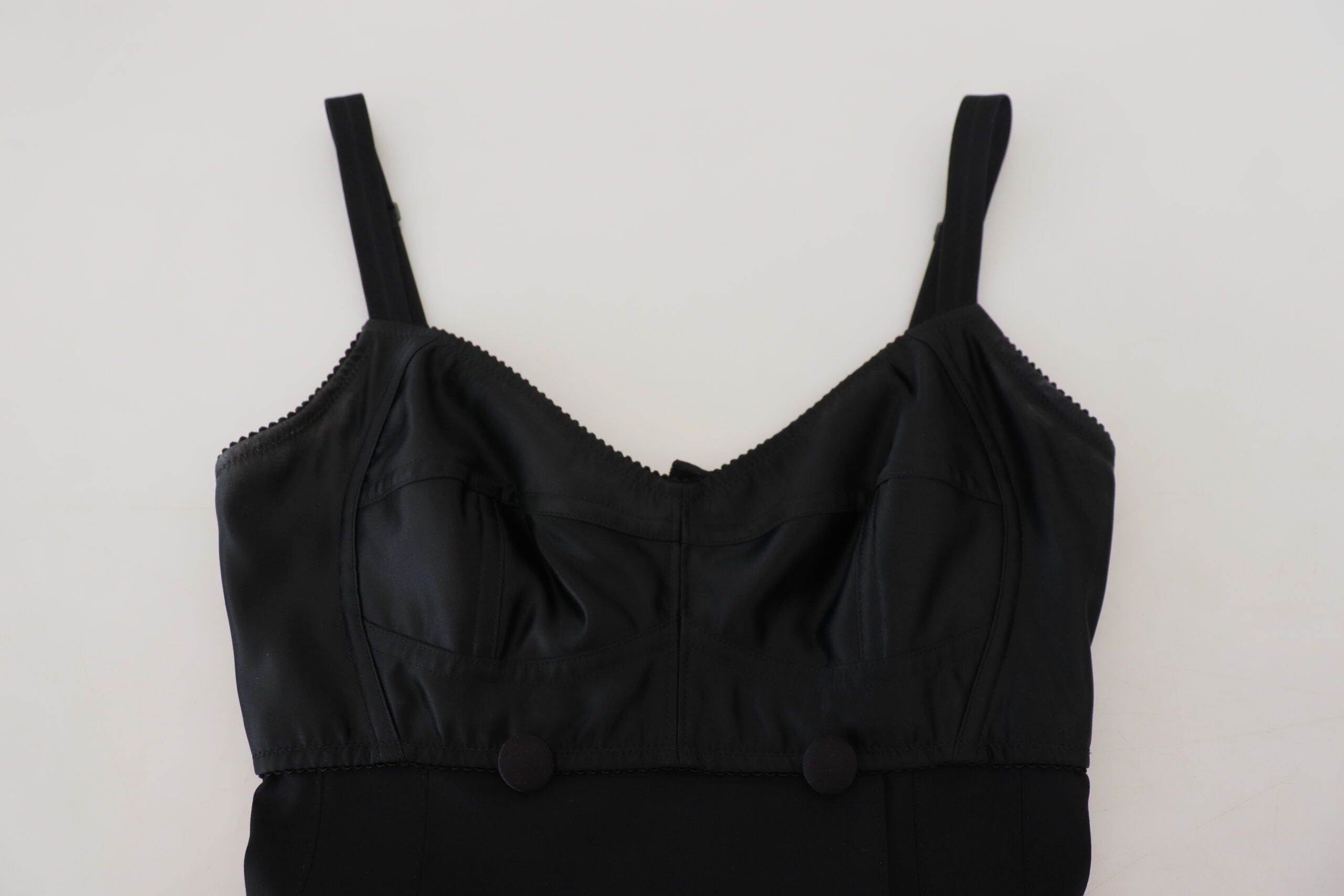 Black Dolce & Gabbana wool stretch sheath mini dress displayed on a hanger with a fitted silhouette and minimal design.