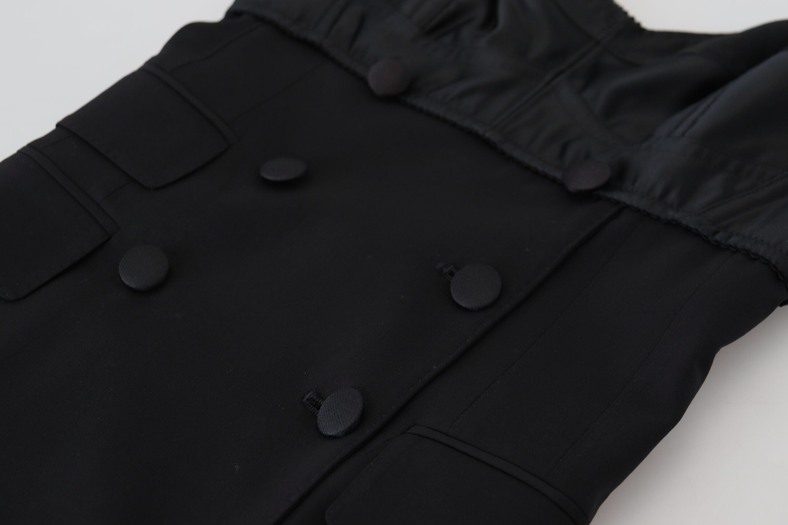 Black fit wool stretch sheath mini dress by Dolce & Gabbana, shown on a model highlighting its tailored silhouette.