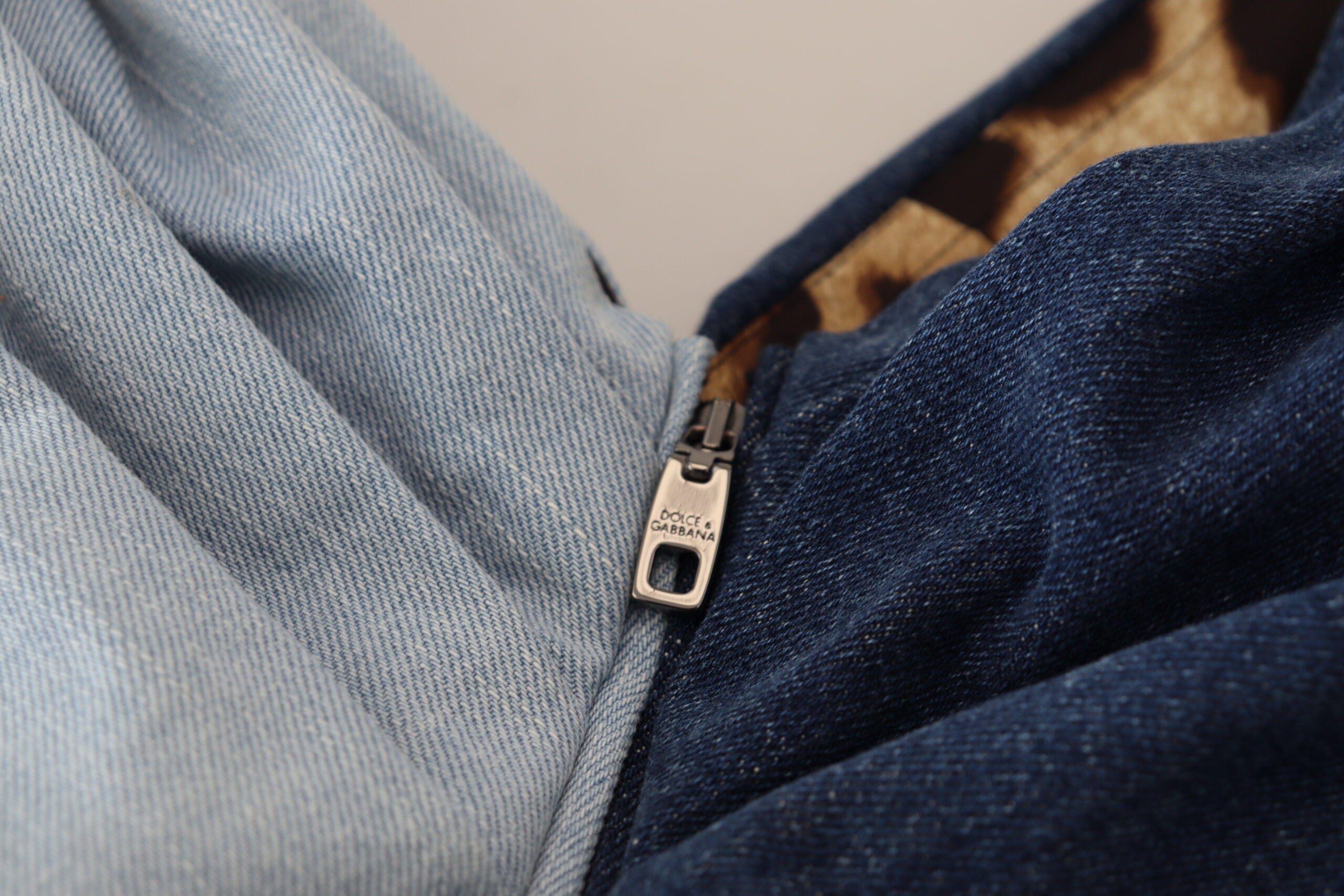 Two-tone blue patchwork denim mini dress by Dolce & Gabbana, showing a stylish sleeveless design with a fitted silhouette.