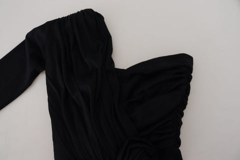 Black wrap sheath wool dress with one-shoulder design by Dolce & Gabbana, shown on a mannequin.