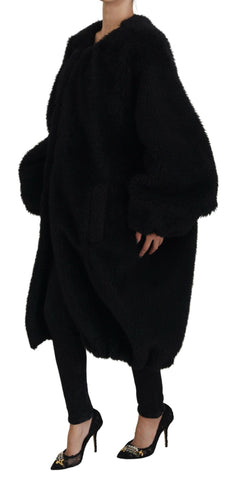 Black Dolce & Gabbana cashmere blend faux fur coat jacket with plush texture and classic design, shown hanging on a clothing rack.
