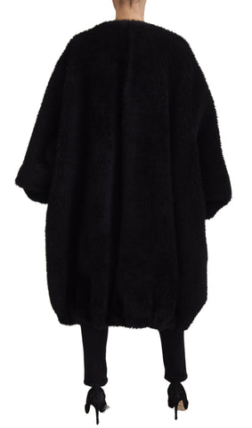 Black Dolce & Gabbana cashmere blend faux fur coat jacket displayed on a hanger with a plush texture and elegant design.