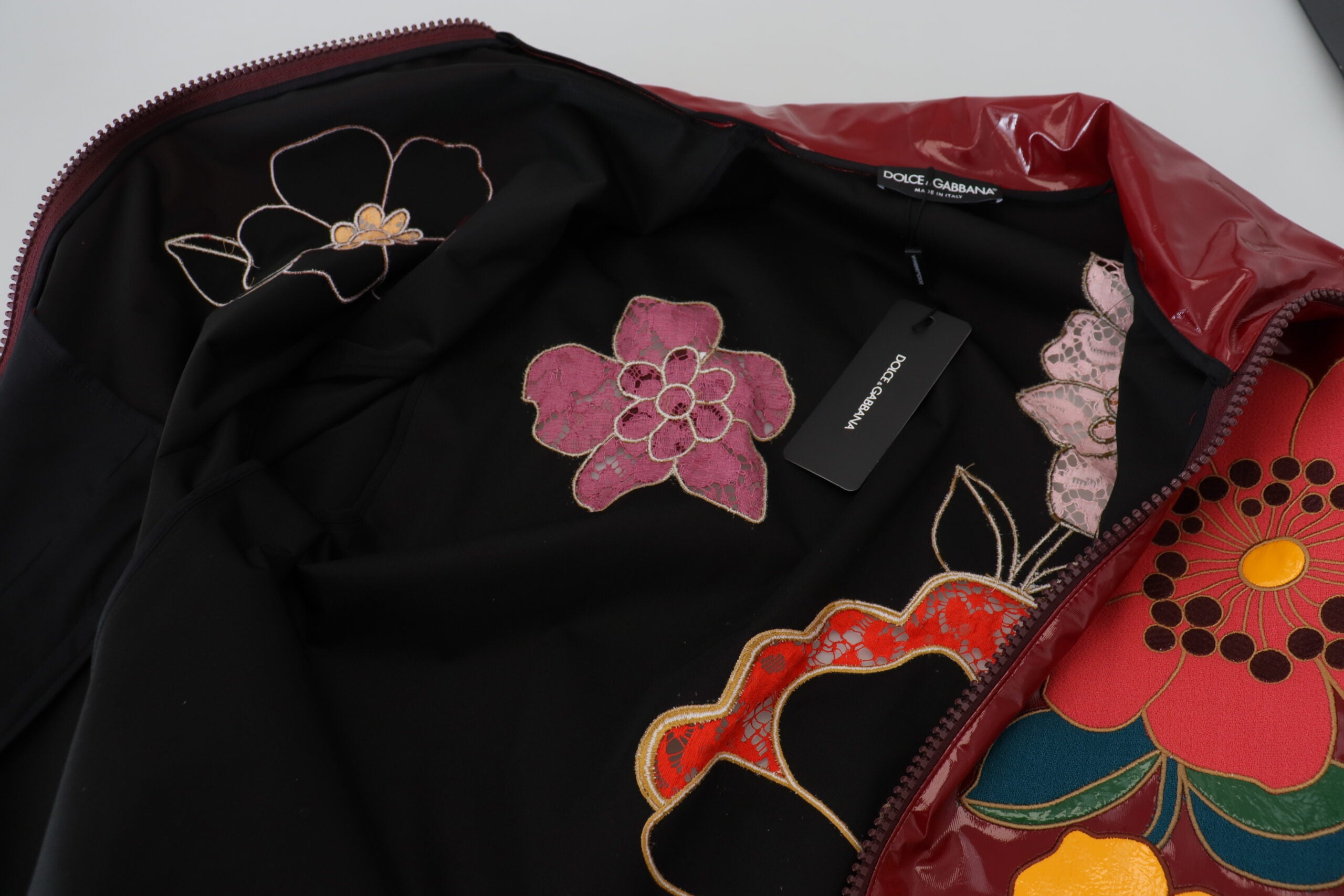 Maroon floral full-zip polyester women's jacket by Dolce & Gabbana, featuring a stylish floral pattern and front zipper closure.