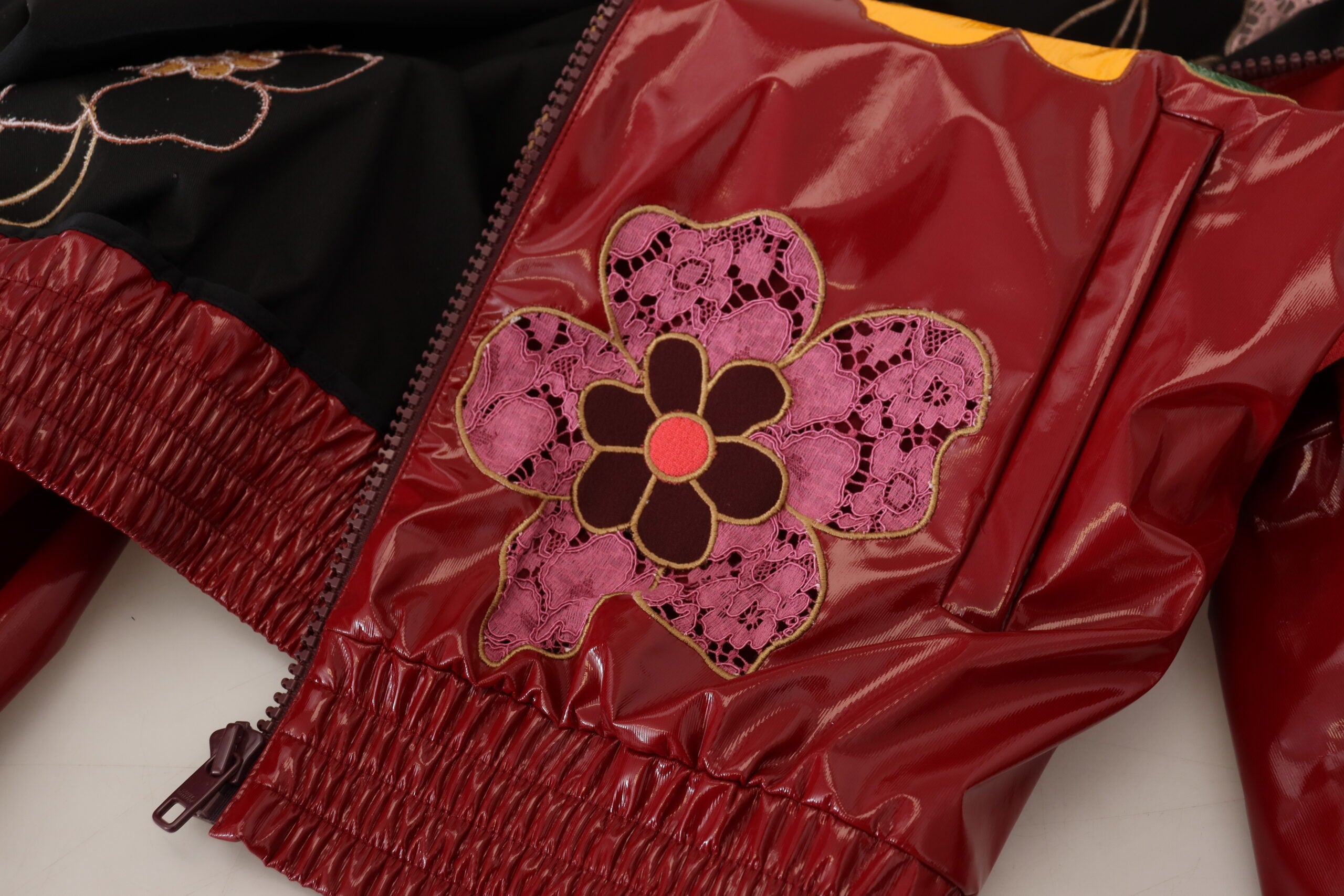 Maroon floral full-zip polyester women's jacket by Dolce & Gabbana, featuring a stylish floral pattern and front zipper.