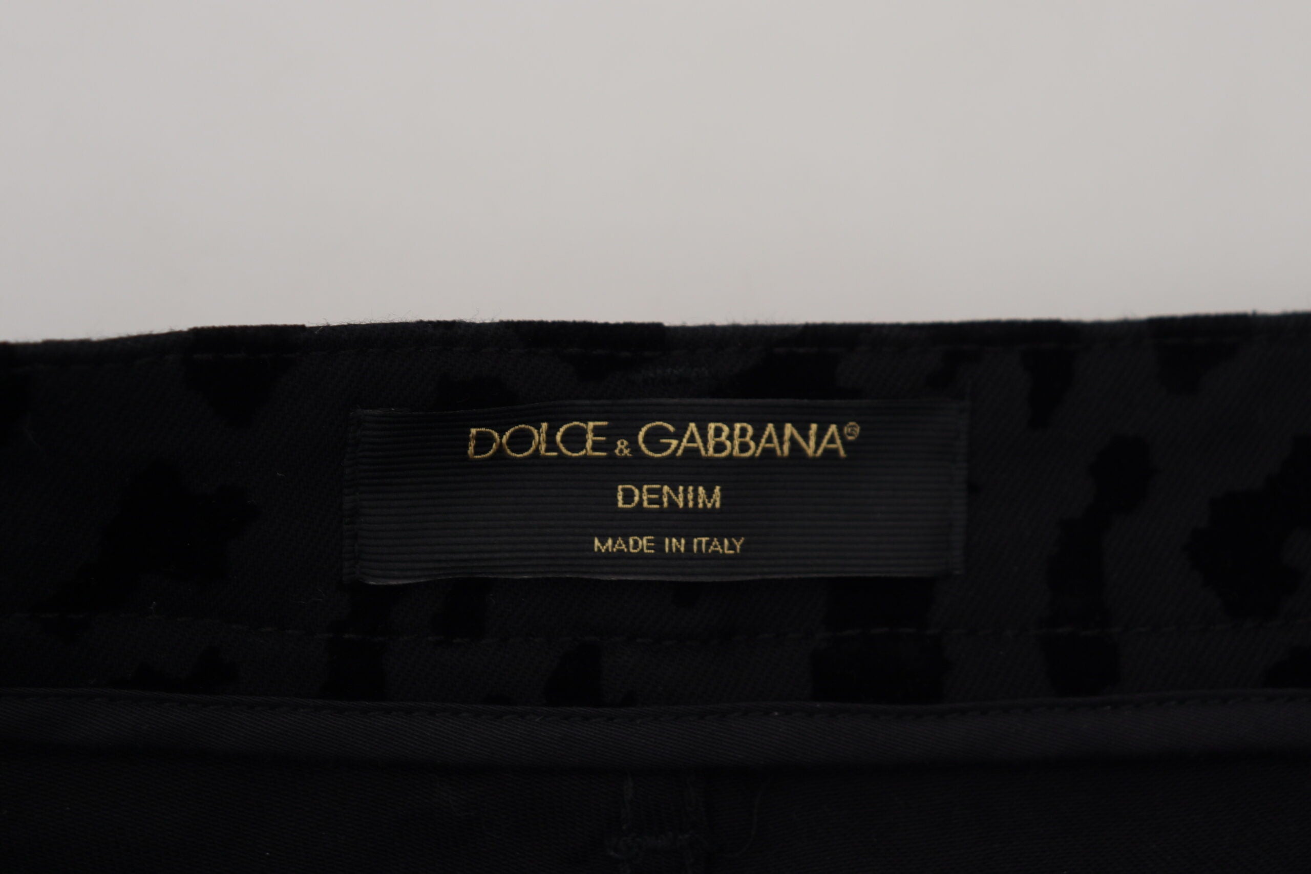 Black denim cotton stretch hot pants shorts by Dolce & Gabbana, showing fitted waist and stylish casual design.