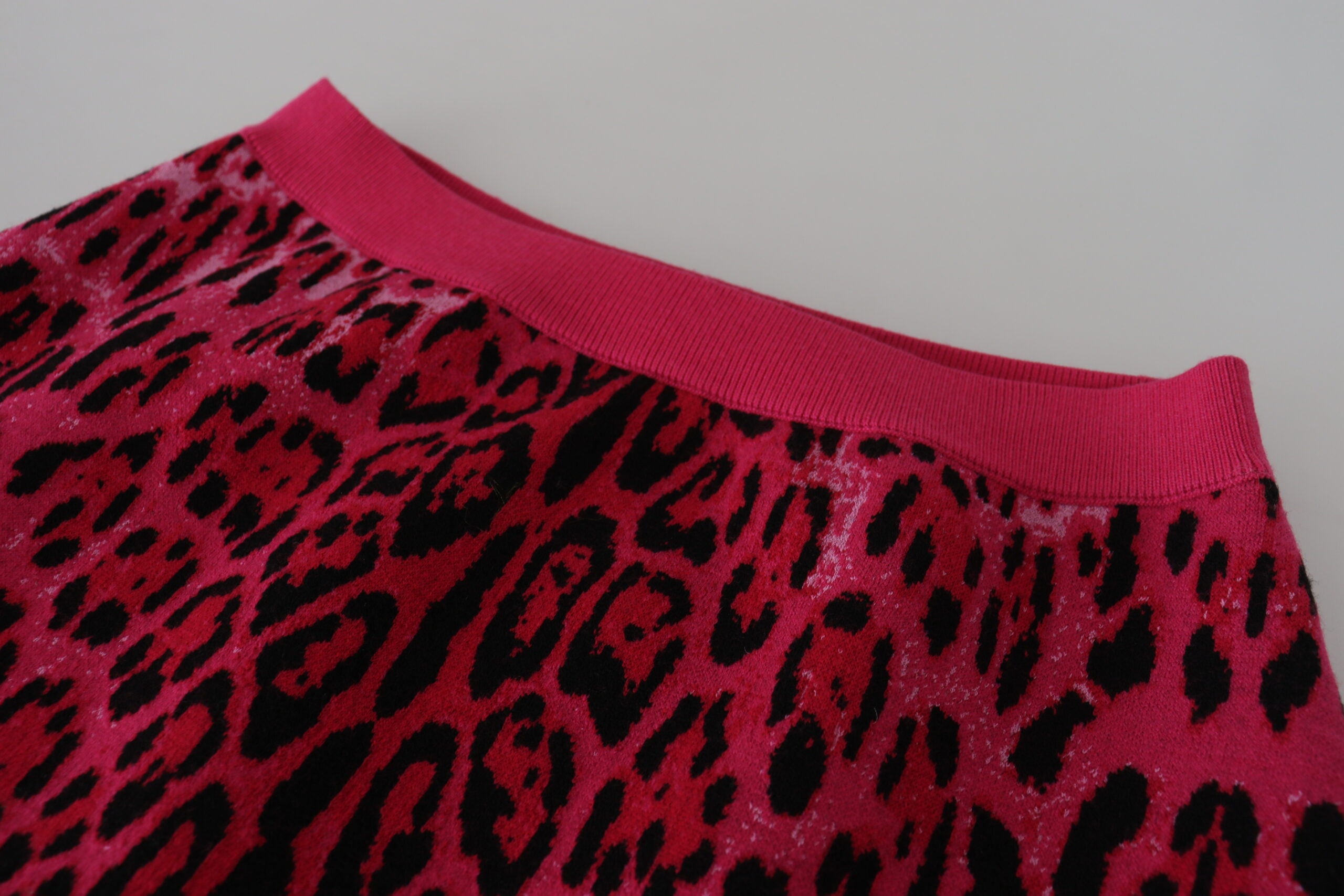 Pink leopard print high waist A-line mini skirt by Dolce & Gabbana, featuring bold animal pattern and stylish fit.