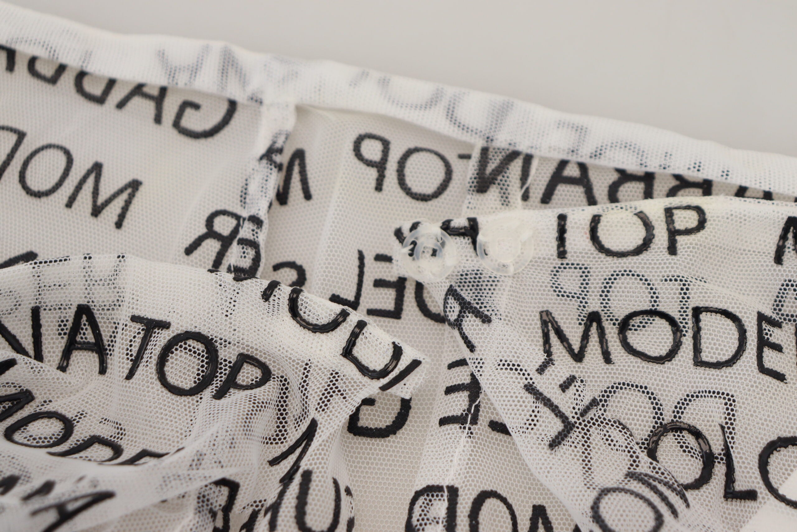 White see-through A-line mini skirt with Dolce & Gabbana logo, stylish and lightweight, showcasing a fashionable and modern design.