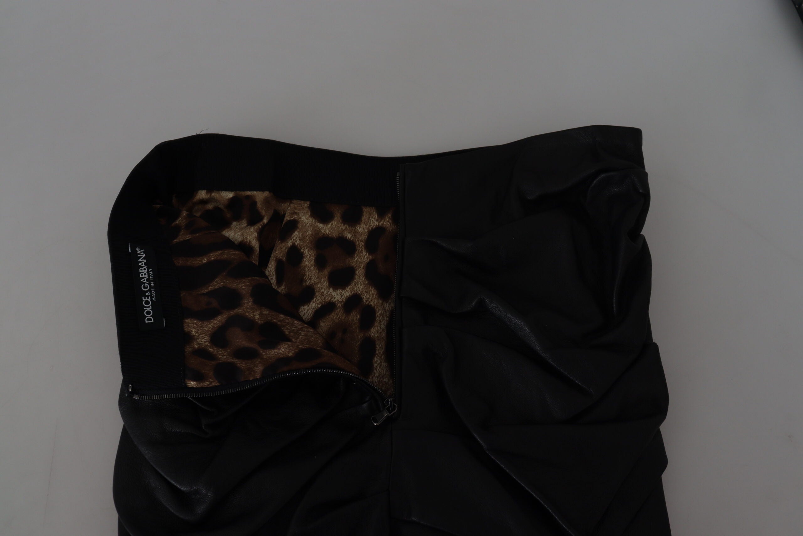 Black lambskin leather A-line mini skirt by Dolce & Gabbana, showing smooth texture and stylish silhouette.
