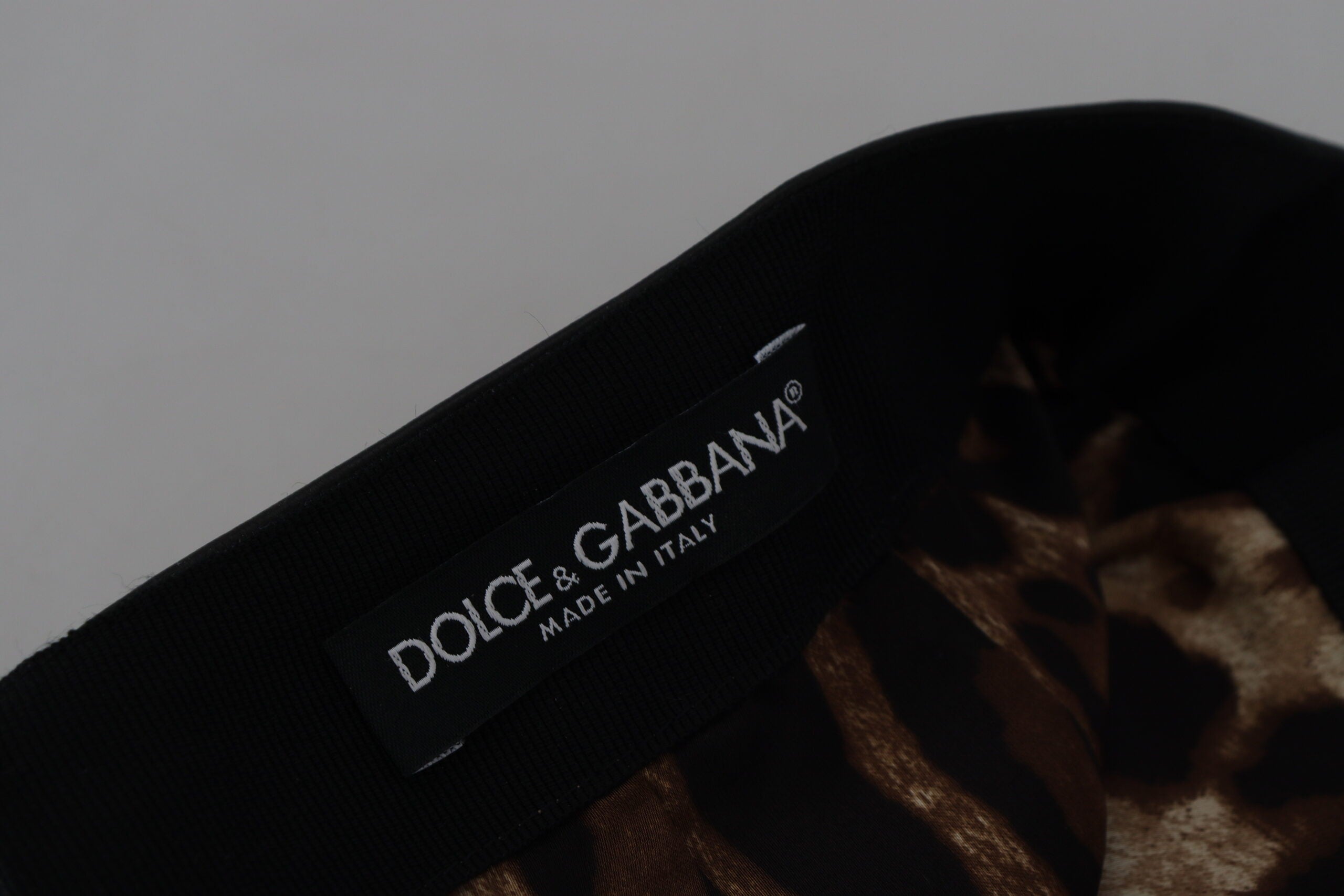 Black lambskin leather A-line mini skirt by Dolce & Gabbana, shown with smooth leather texture and classic A-line silhouette.
