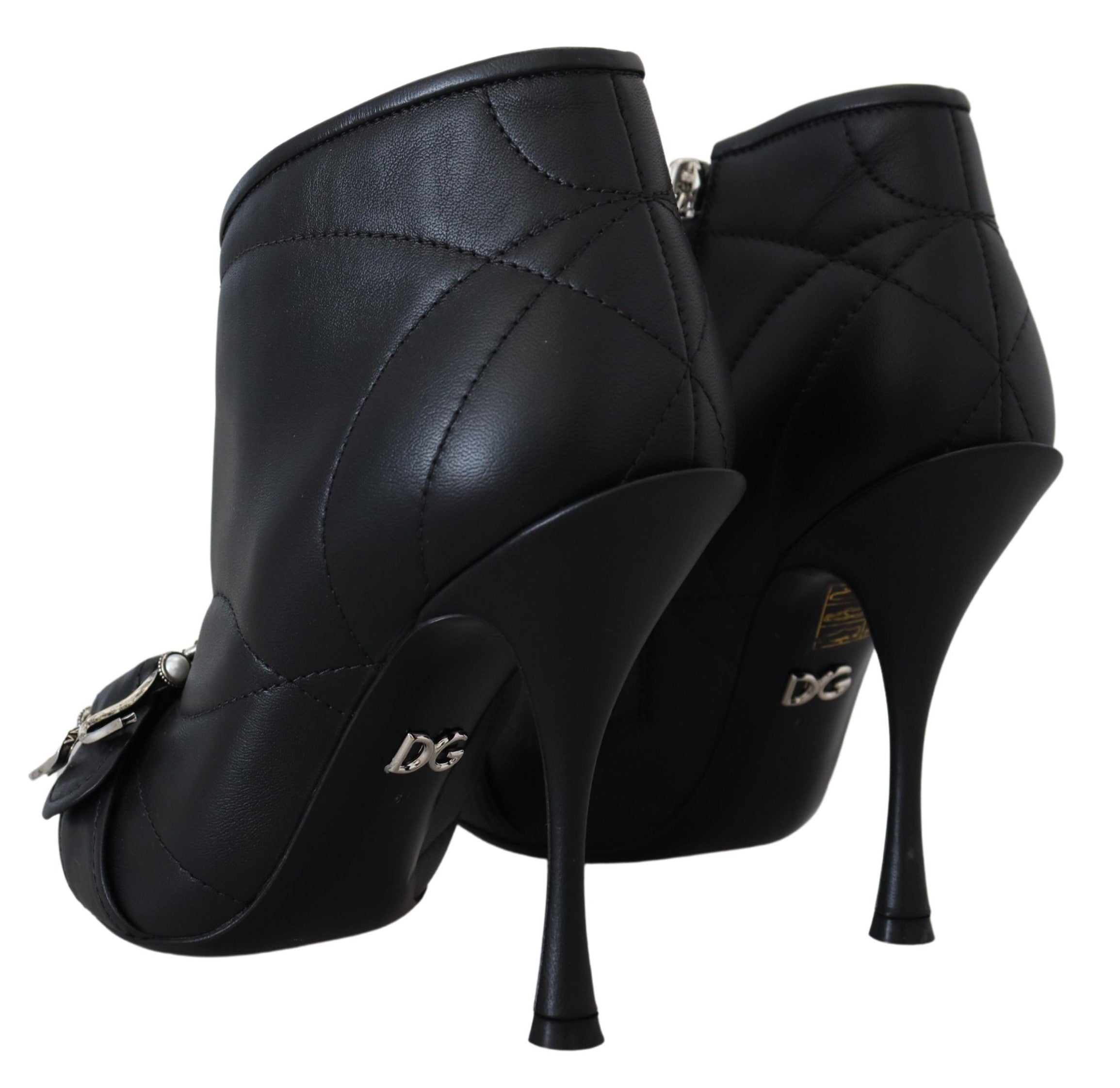 Black Devotion quilted buckled ankle boots by Dolce & Gabbana with a sleek design and buckle details.