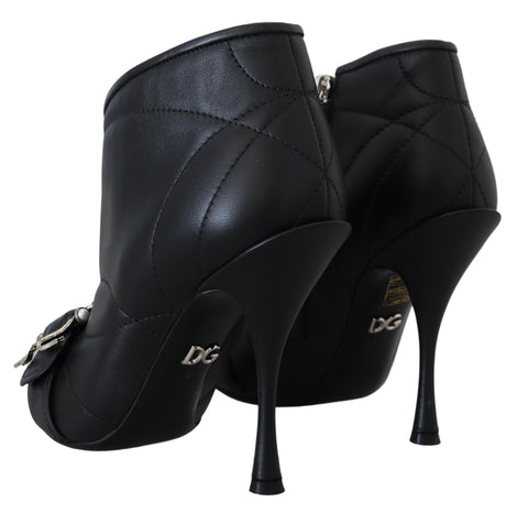 Black Devotion quilted buckled ankle boots by Dolce & Gabbana with a sleek design and buckle details.