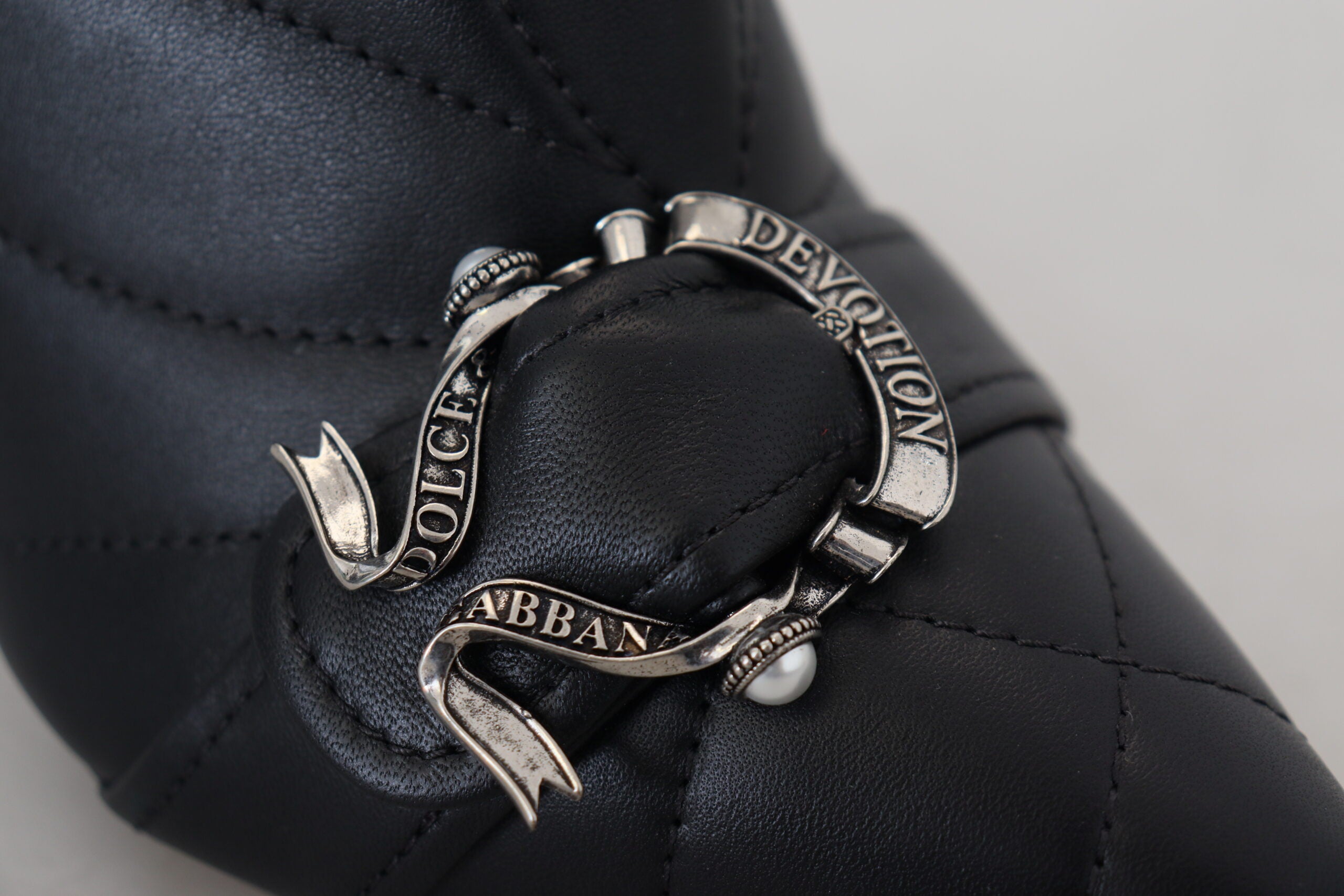 Black Devotion quilted buckled ankle boots by Dolce & Gabbana, featuring a sleek design with buckle accents and padded quilted texture.