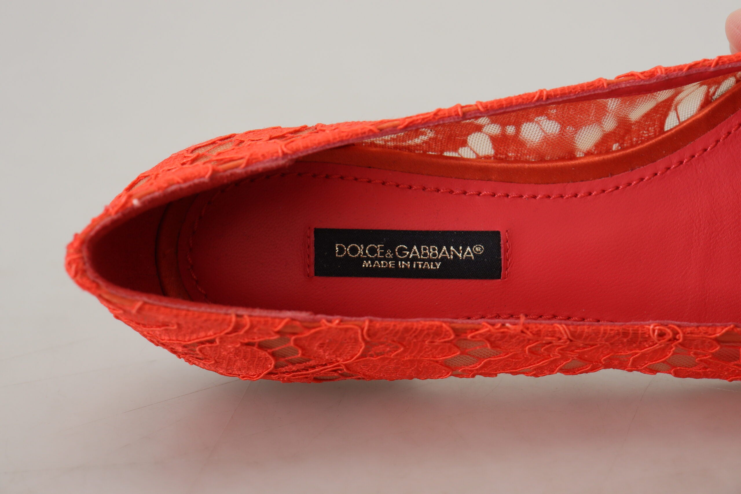 Red Taormina lace ballet flats with crystal embellishments by Dolce & Gabbana, featuring delicate lace and elegant design.