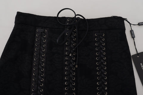 Black brocade mini pencil skirt by Dolce & Gabbana with above-the-knee length and intricate floral pattern.