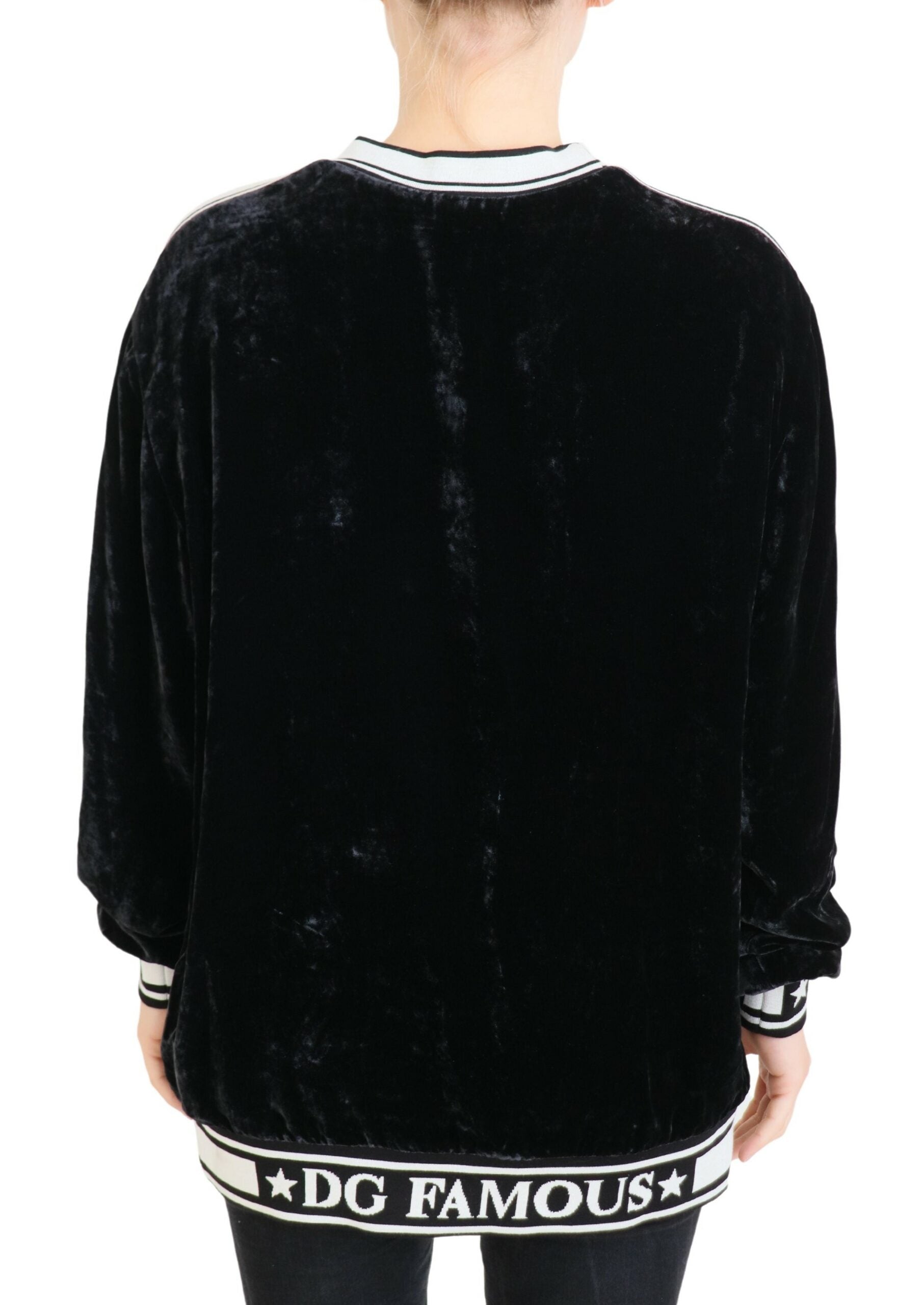 Black velvet crewneck pullover sweater by Dolce & Gabbana, showing soft fabric and classic fit on a mannequin.