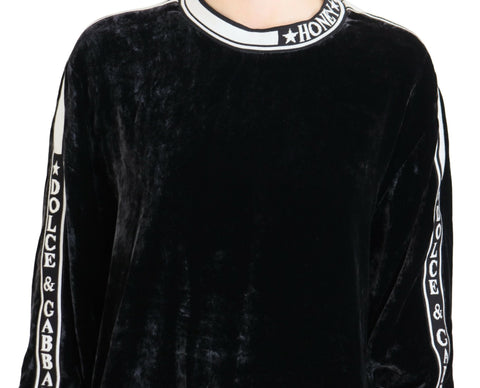Black velvet crewneck pullover sweater by Dolce & Gabbana, close-up showing soft fabric and classic design.