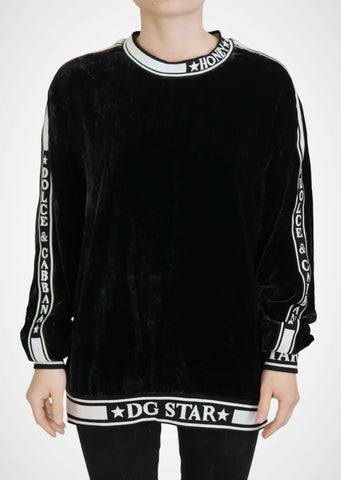 Black velvet crewneck pullover sweater by Dolce & Gabbana, close-up showing soft fabric and classic fit.