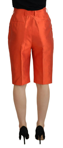 Orange silk high waist cropped pants by Dolce & Gabbana, showing the tailored fit and smooth fabric detail.