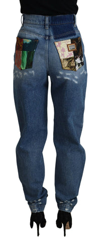 Blue tattered skinny denim cotton jeans by Dolce & Gabbana displayed on a model.
