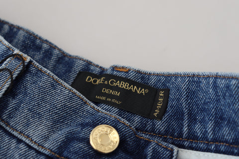 Blue tattered skinny denim cotton jeans by Dolce & Gabbana, showing distressed details and slim fit style.