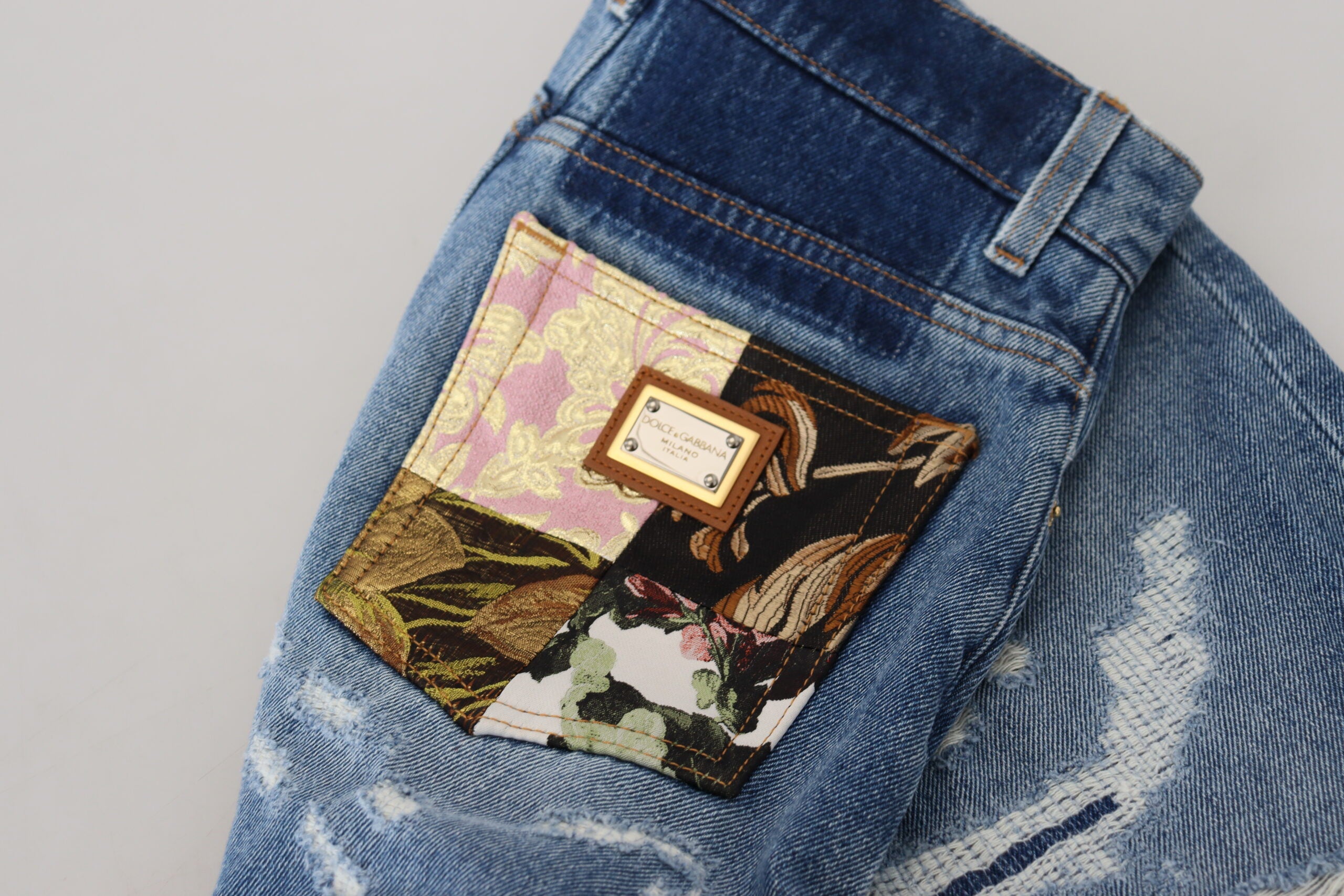 Blue tattered skinny denim cotton jeans by Dolce & Gabbana, showcasing distressed details and slim fit style.