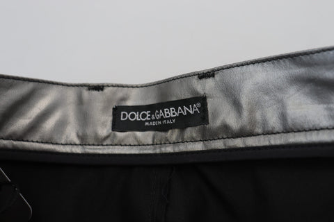 Metallic silver high-waist skinny pants by Dolce & Gabbana, shown on a model with a close-up of the shiny fabric and fitted style.