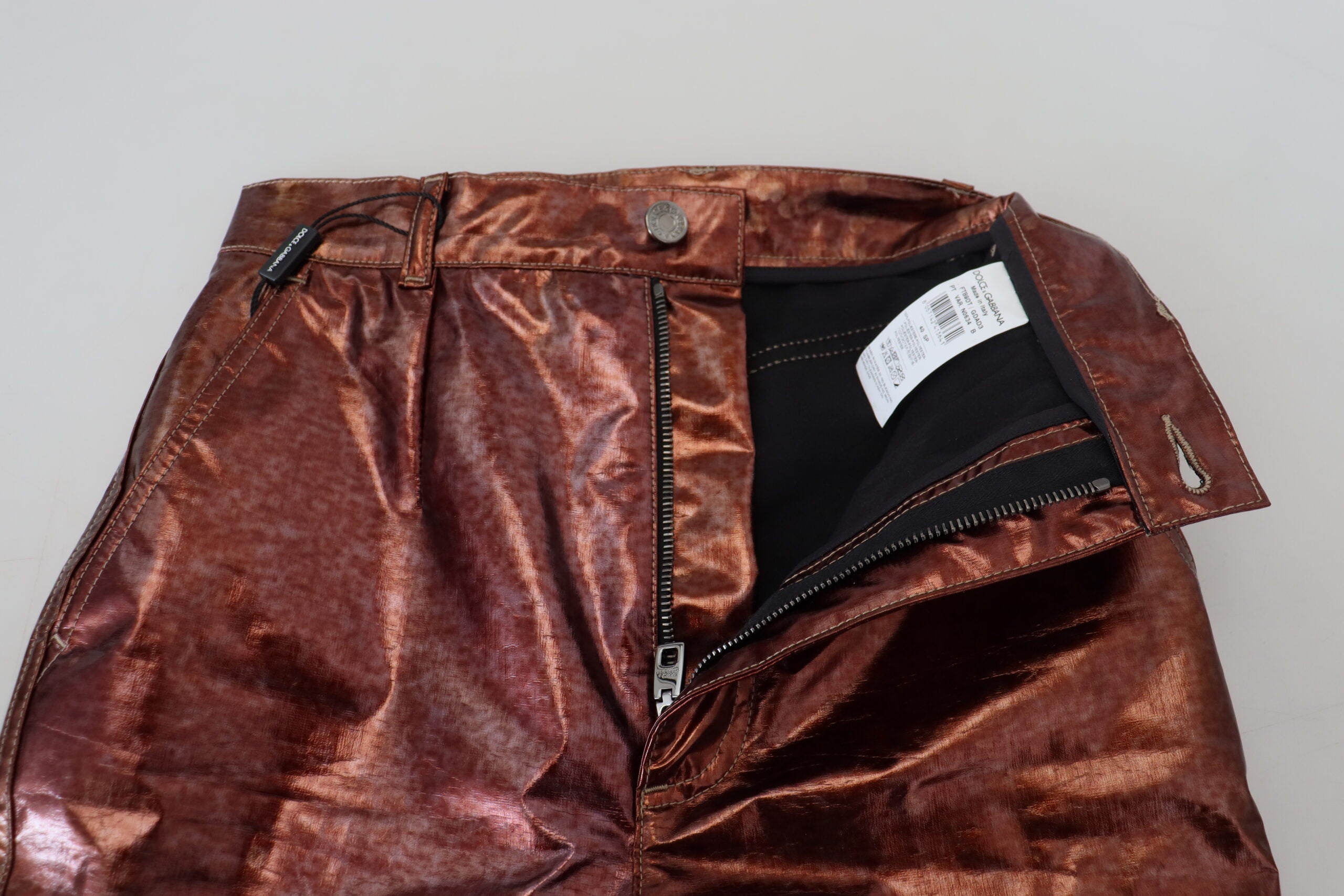 Metallic bronze high waist skinny jeans by Dolce & Gabbana, shown with a close-up of the shiny, form-fitting denim fabric.