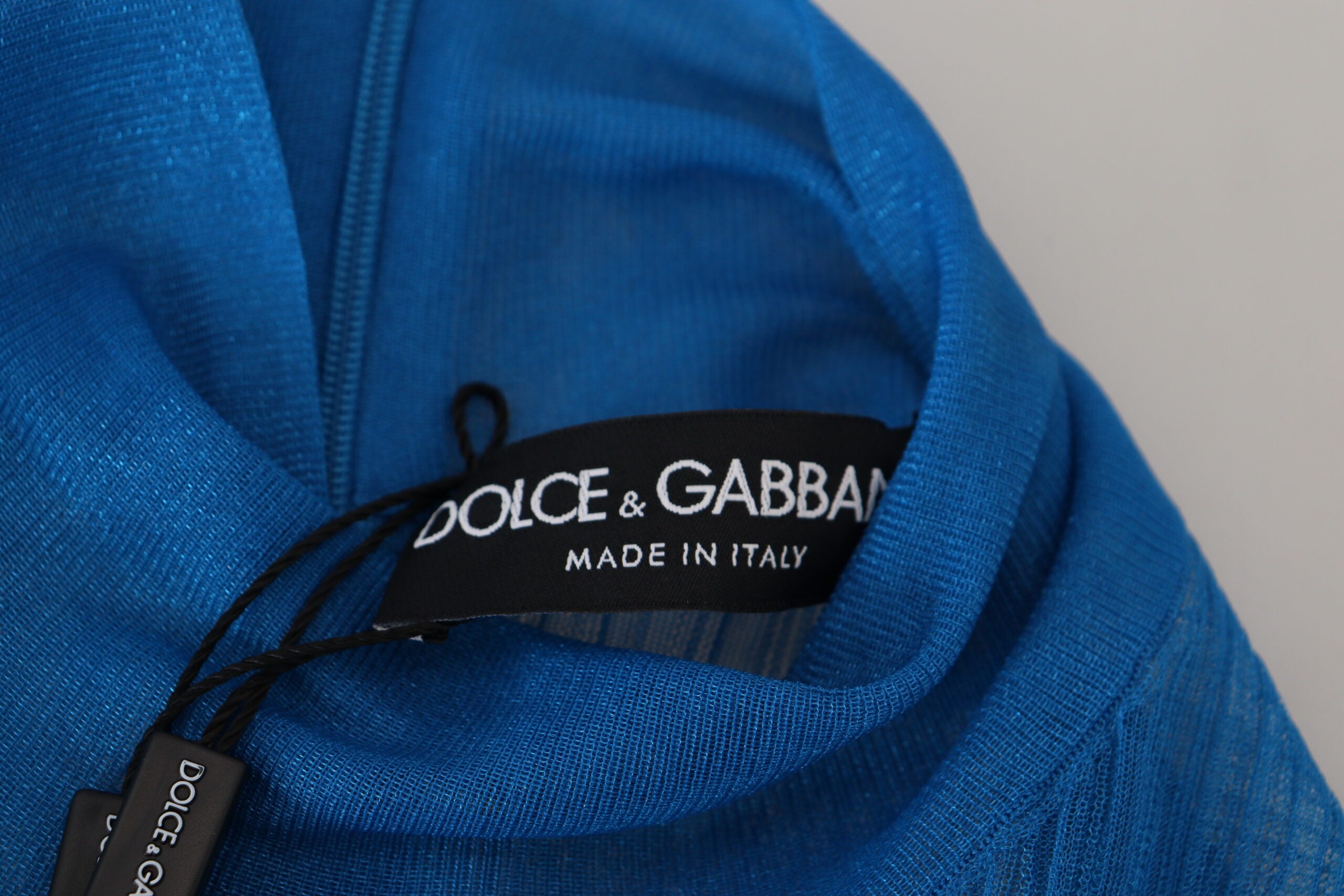 Blue mesh turtleneck long sleeve blouse top by Dolce & Gabbana, featuring a fitted design and sheer fabric.