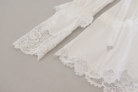 White cotton blouse with lace trim and turtle neck, designed by Dolce & Gabbana, shown on a model.