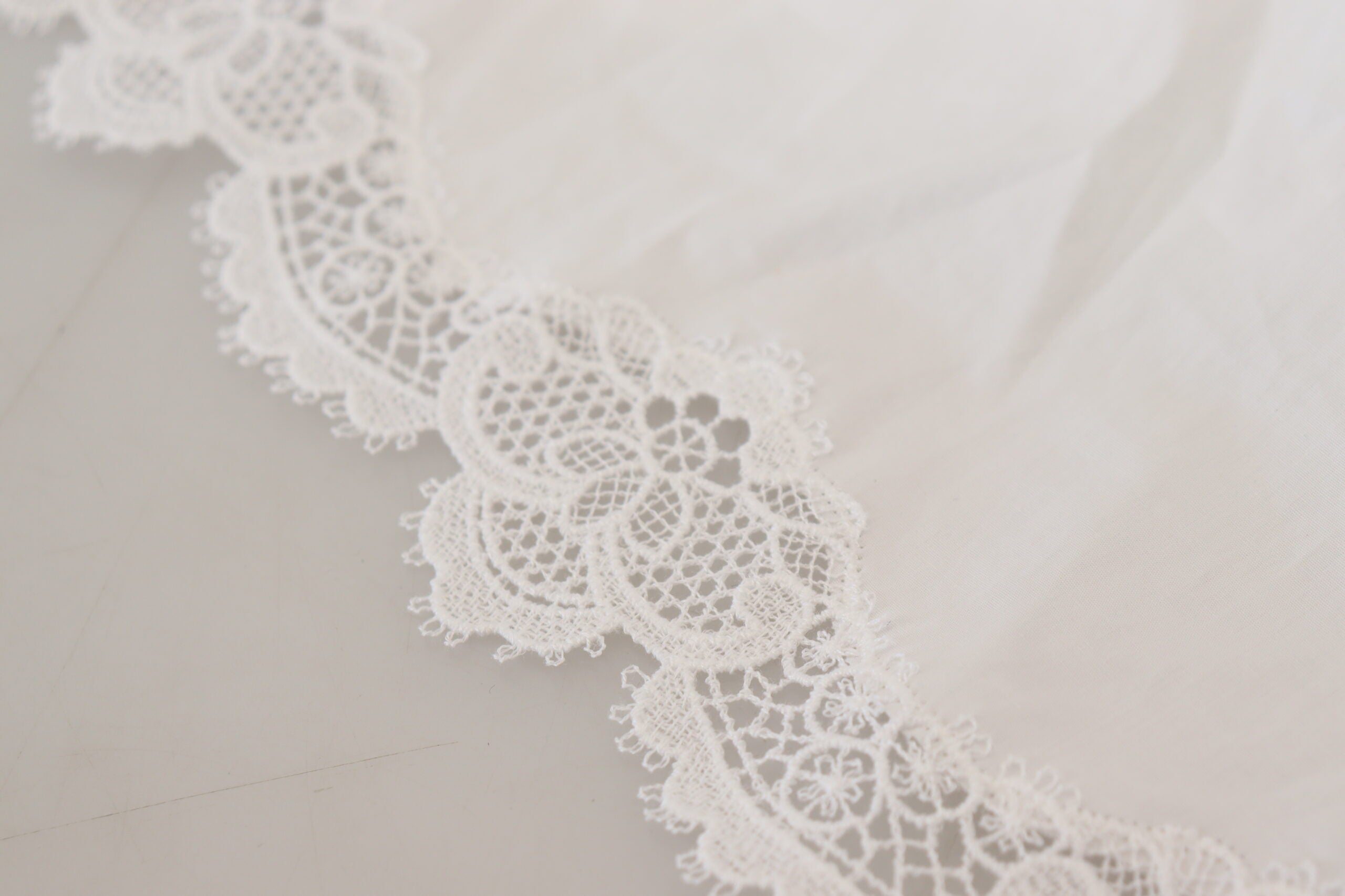 White cotton blouse with lace trim and turtle neck by Dolce & Gabbana, featuring long sleeves and elegant design.