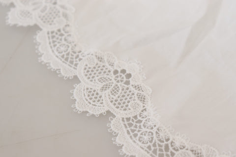 White cotton blouse with lace trim and turtle neck by Dolce & Gabbana, featuring long sleeves and elegant design.