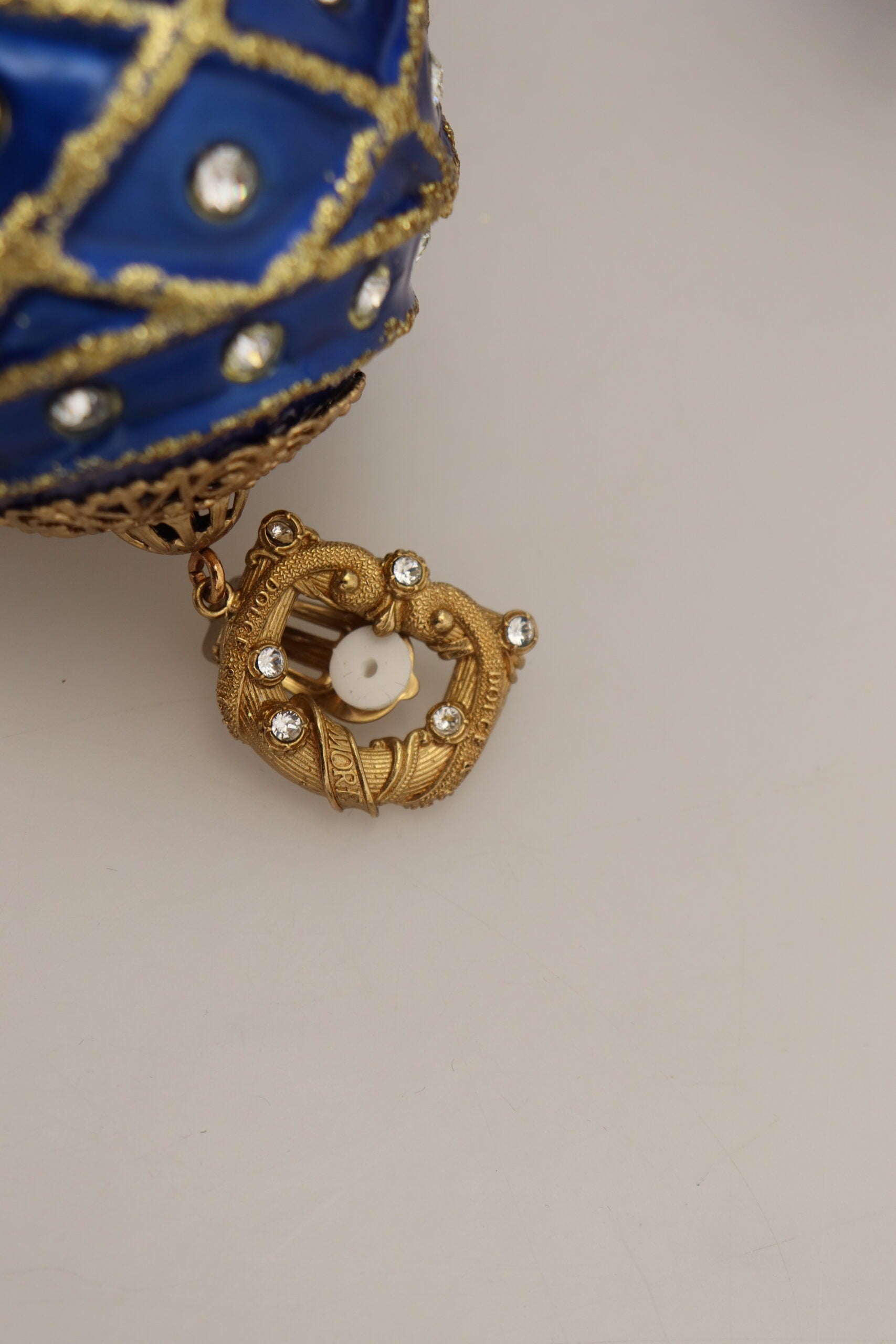 Gold brass and blue dangle ball crystal clip-on earrings by Dolce & Gabbana, featuring elegant dangling design and sparkling crystals.