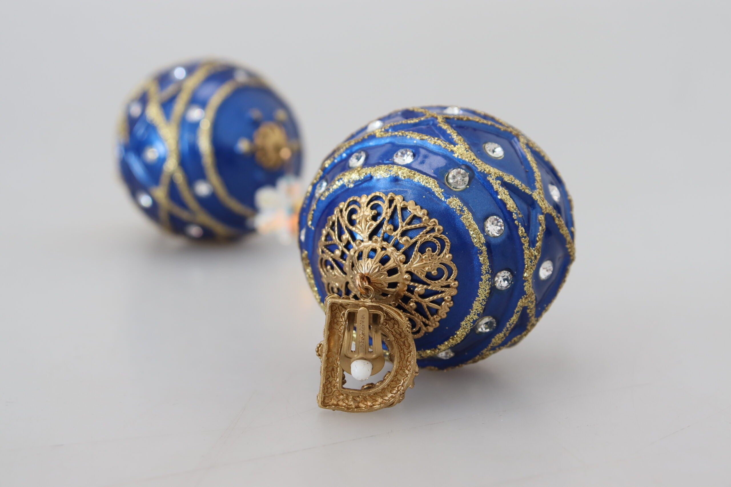 Gold brass and blue dangle ball crystal clip-on earrings by Dolce & Gabbana, featuring elegant dangling design.