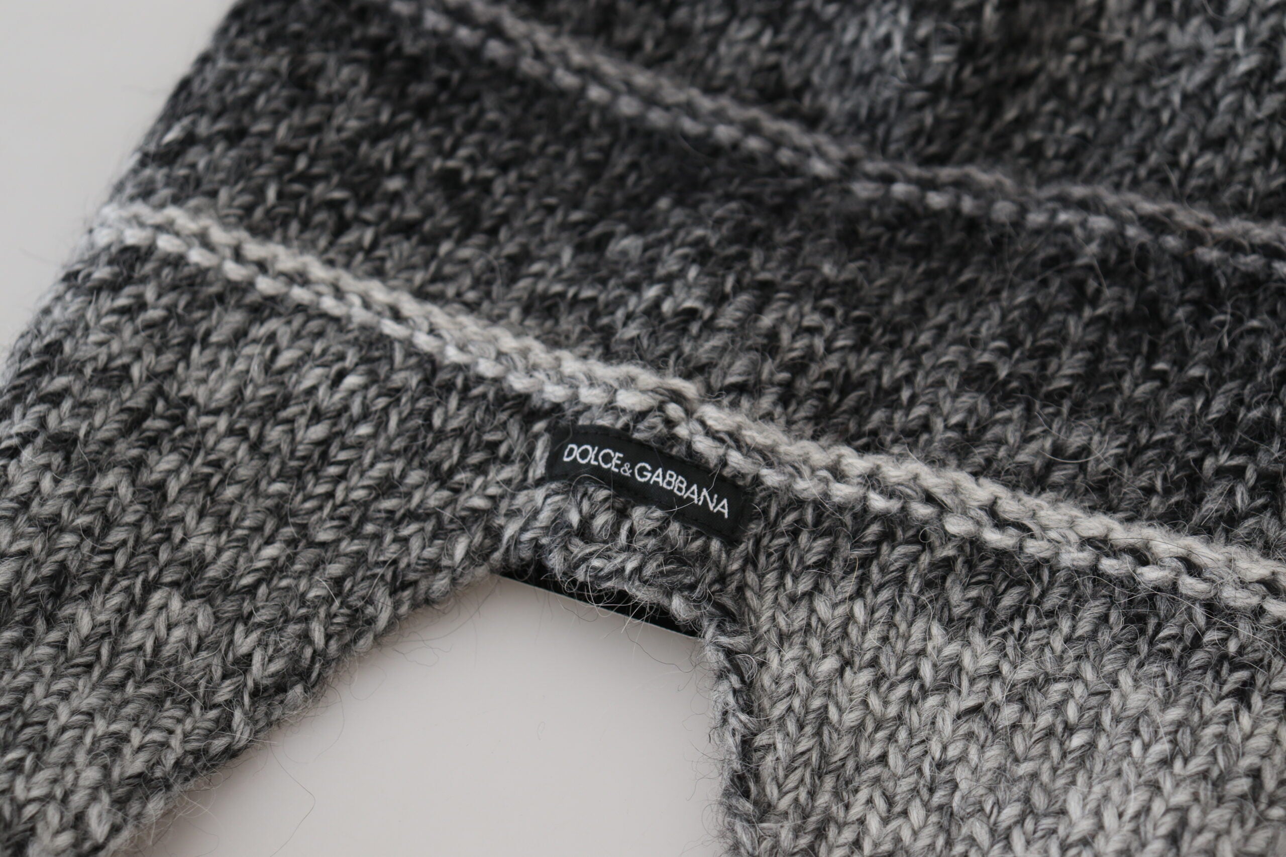 Gray warm fleece ear flap knit beanie hat by Dolce & Gabbana, showing soft fleece lining and cozy ear flaps for winter warmth.
