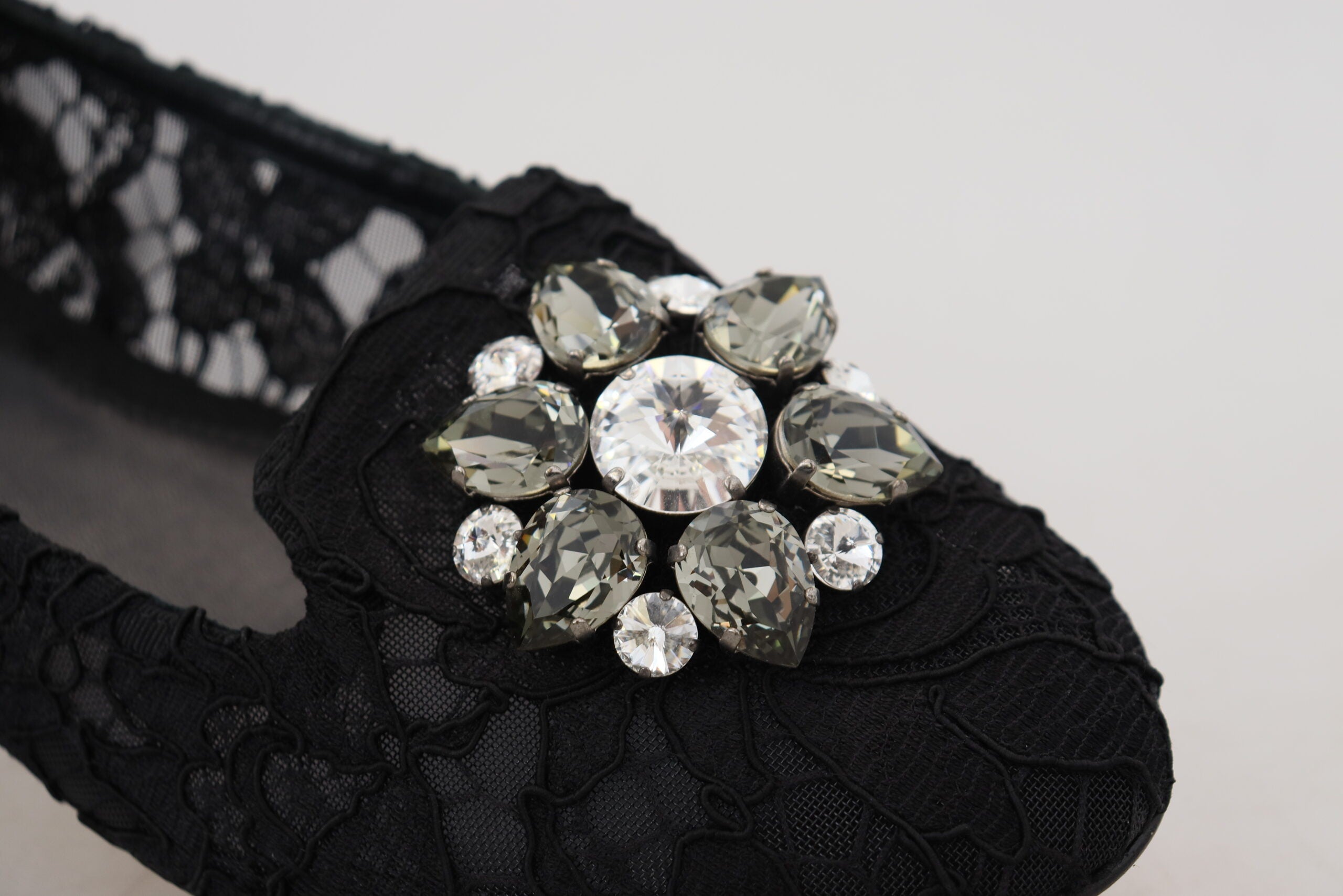Black Taormina lace flats shoes with crystal embellishments by Dolce & Gabbana, featuring intricate lace details and elegant design.