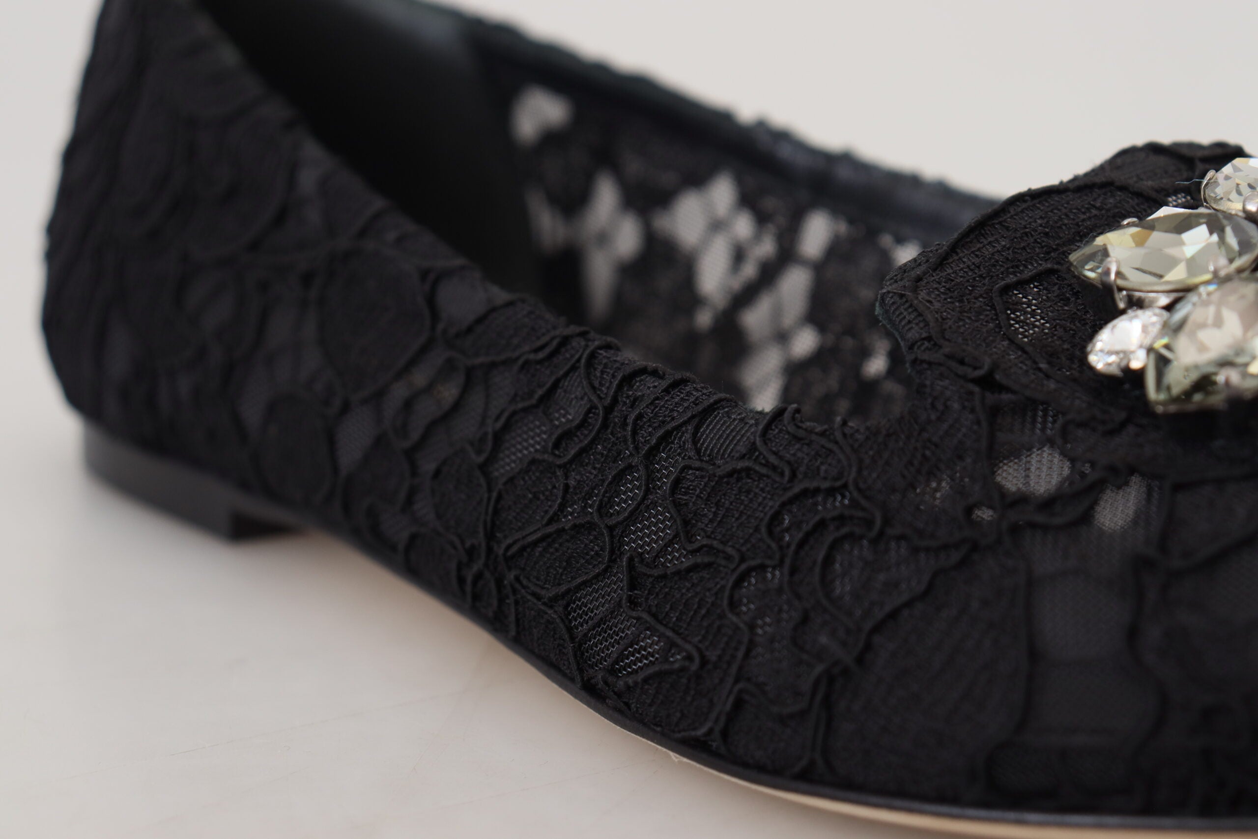 Black Taormina lace flats shoes with crystal embellishments by Dolce & Gabbana, featuring a sleek slip-on design and intricate lace detailing.