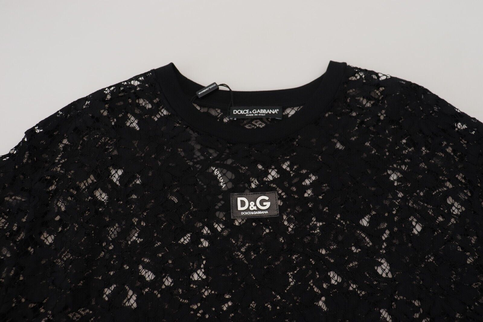 Black floral lace cotton shift mini dress by Dolce & Gabbana, featuring intricate lace details and a stylish, fitted silhouette.