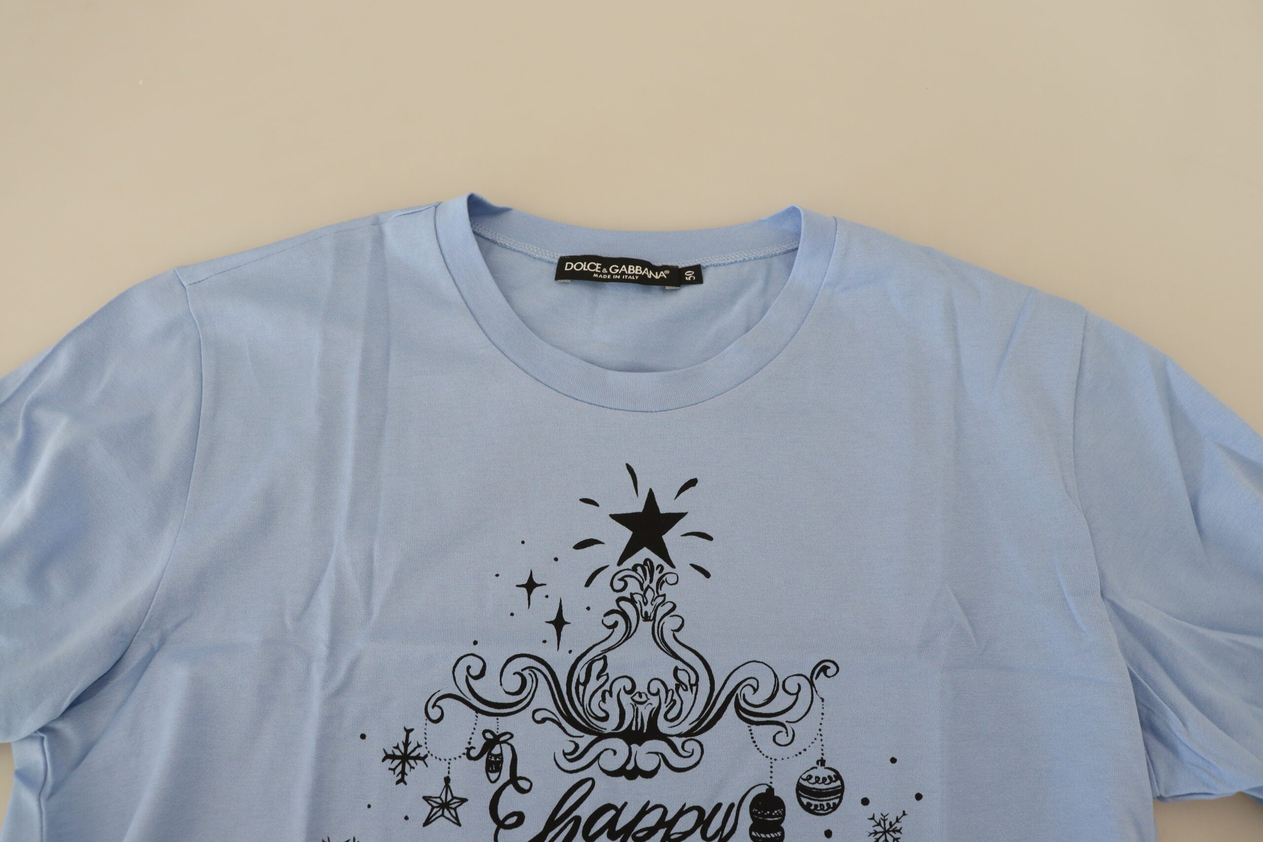 Light blue Dolce & Gabbana cotton T-shirt with Happy New Year 2017 print, casual short-sleeve design on a white background.